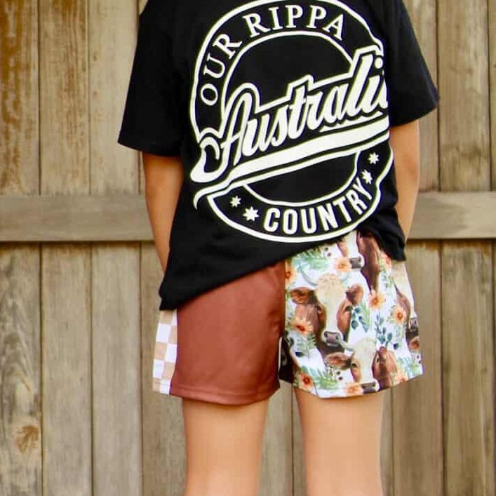 Two people wearing black t-shirts with 'Our Rippa Australia' text, standing on a wooden platform.